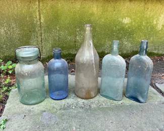 173 fourvintageglassbottlesandajar