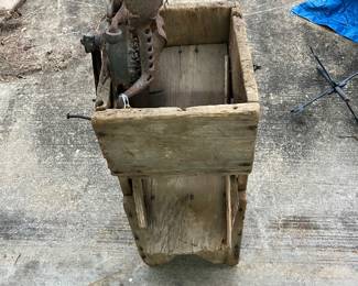 Old Blackhawk corn sheller on a wooden box, display 