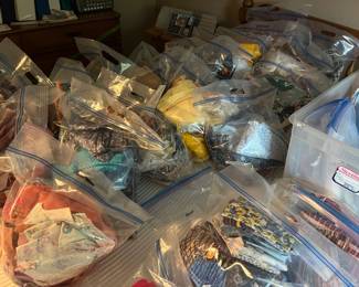 Bags of quilting and sewing fabric, organized by type, color, style.