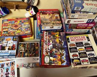 Table full of puzzles! Range of 300 piece puzzles up to 1000 piece puzzles,