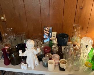 Vases, candle stick holders, candles, vintage pop bottles and jars.