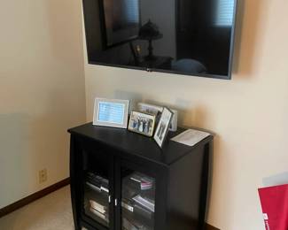 145 LG Flat Screen TV with Black Media Cabinet Glass Door