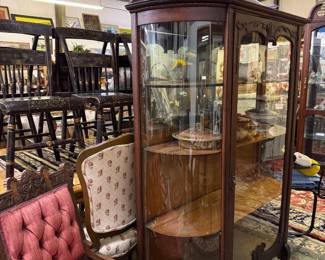 Curved glass front curio