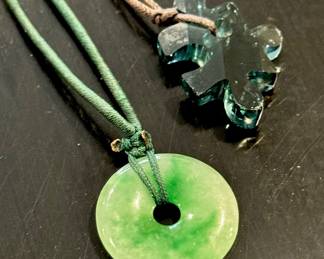 (Left: Nephrite Jade circular necklace- $60), (Right: Puzzle piece pendant necklace- $30)