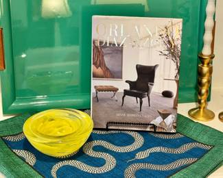 (Sheila Bridges for Williams Sonoma Home green lacquered tray- 26x16- $100), (Kosta Boda Atoll yellow swirl art glass bowl- 7"D- $60), (Snake pillow cover in the style of Jonathan Adler- 21"- $50)