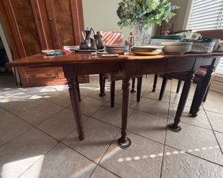 Dining table. Ends fold down. Includes an extra leaf