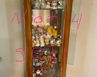 Cabinet not for sale but salt and pepper shakers and figurines for sale.