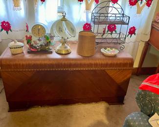 Antique cedar chest with veneer. In good shape other than one side hinge that holds door in the open position can be replace or straightened.