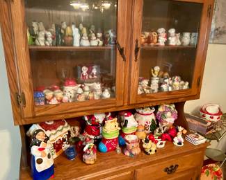Cookie jars, German wooden spoon figurine from late 70’s, salt and pepper shakers. Cabinet for sale as well.