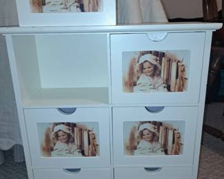 white wooden multi-drawer storage cabinet features individual photo frames inset into each drawer front.    35.00