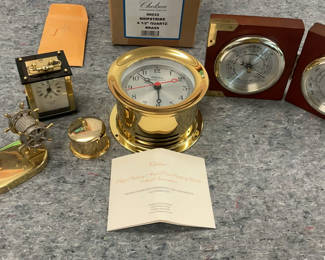 Lot 7: Brass Chelsea nautical clock set with barometers and ship wheel