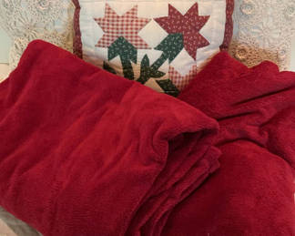Lot 70: Decorative pillows with crocheted lace covers and red throw blanket