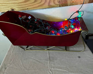 Lot 153: Red Sleigh-Shaped Container with Multicolor Christmas Lights