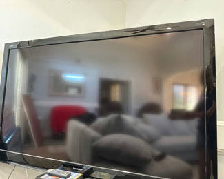 Lot 7: Sharp AQUOS flat-screen TV with remotes and media discs