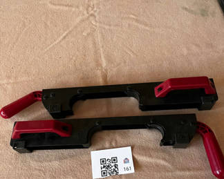 Lot 161: Pair of black plastic bar clamps with red handles