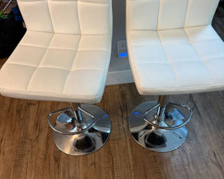Lot 170: Two white tufted bar stools with chrome pedestal bases