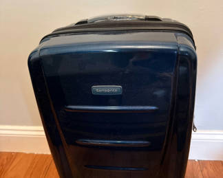 Lot 61: Blue Samsonite hard-shell rolling suitcase