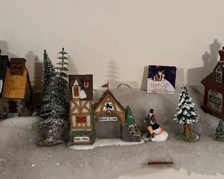 Large collection of Department 56 Dickens Village houses and accessories.