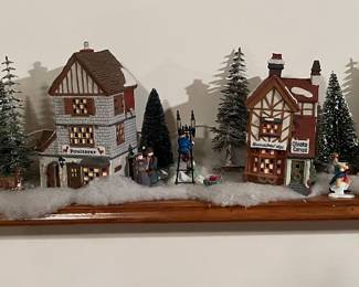 Large collection of Department 56 Dickens Village houses and accessories.