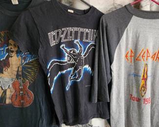 collection of vintage rock band T-shirts, including designs from Iron Maiden, AC/DC, and Anthrax