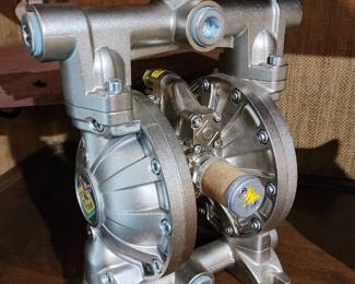 Rasm double diaphragm pump with a metallic housing, multiple bolts, and a central logo featuring a bird emblem