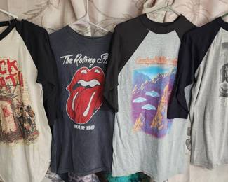 collection of vintage rock band T-shirts, including designs from Iron Maiden, AC/DC, and Anthrax