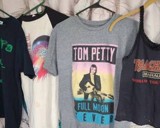 collection of vintage rock band T-shirts, including designs from Iron Maiden, AC/DC, and Anthrax