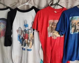 collection of vintage rock band T-shirts, including designs from Iron Maiden, AC/DC, and Anthrax