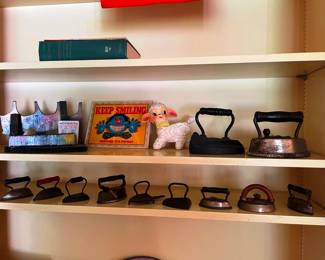 A collection of antique toy irons
