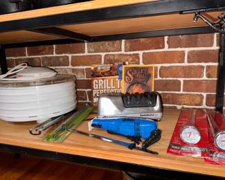 Left to Right: NESCO  Food Dehydrator, $25. Mister Twister Electric Fillet Knife, $15. Cookbooks: Grill Perfection and A Skillet Full. $8 each. Chef's Choice 1520 Electric Sharpener, $50. CDN Long Stem Fry Thermometers, $6 each. 