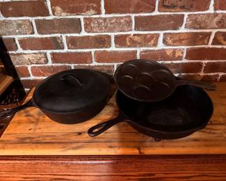 Cast Iron- Left to right: Unmarked BSR, Deep Covered Skillet/Chicken Fryer with lid.  Highly collectible Red Mountain era or early Century Series crossover era. Produced between 1940s and late 1950s. $80.  Norpro Swedish Plett Pan. $25. Large Lodge Workhorse Skillet $35.