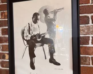 Framed print is "Taps for Louis" (1978) Signed by James Russell, a notable local artist known for his imagery and portraits in New Orleans. $45