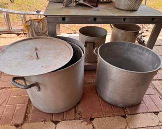 Left to Right and Front to Back: Large Boiling Pot with Lid & Basket. $60. Large Stock Pot. No Lid or Strainer Basket. $30. Pot with the Drop-Down Handle. $25. Standard Small Stock Pot. $25. 