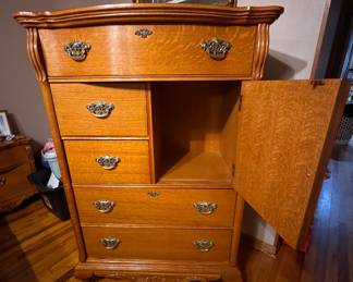 Solid Oak Lexington Furniture Victorian Sampler Collection Door Chest featuring distinctive carved scroll door detailing, quarter-sawn oak grain, and ornate brass-finish hardware. Approx. 33w x 52h x 18d. $500