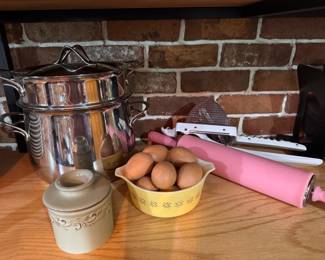 Left to Right: French Butter Bell Crock. $15. Stainless Steel Double Boiler/Steamer Pot Set. $30. (SOLD)  Vintage Pyrex "Butterfly Gold" small mixing bowl. $15. Set of wooden eggs. $15. Pink Silicone Rolling Pin. $12. Mandoline Slicer/Grater Hand Tool. $12. 