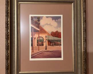 Framed artwork depicts a New Orleans street scene. Artist, Gail Brittain Gilchrist. Numbered 73/350. $60.00