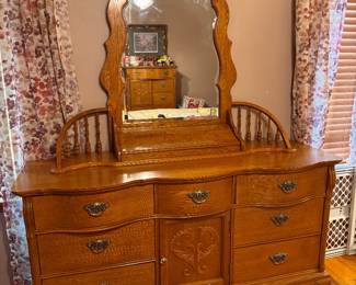 Solid Oak Lexington Furniture Victorian Sampler Collection Triple Dresser and matching Spindle Mirror. 9 drawers. Approx. 64w x 86 1/2 h x 21d. $600.