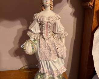 Pair of vintage MCM Italian porcelain figural table lamps features hand-painted 18th-century style aristocratic court or colonial couple figurines set on dark circular bases with scalloped fabric shades. Approx. 35h x 7" w base. $