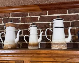 Left to Right: Lindy's Stainless Steel 10-Cup Stovetop Drip Coffee Maker, with under-tray. $40. Vintage White Enamelware Biggin with Brown Ombre Base (large). $45. Vintage White Enamelware Biggin with Brown Ombre Base (Medium). $40. Vintage Plain White Enamelware Biggin with Black Trim. $45. Vintage Blue & White Speckled Graniteware Biggin. $55. 