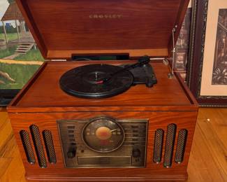 Crosley Musician Entertainment Center. All-in-one retro-style audio station housed in a wooden veneer cabinet. Functions: 3-speed turntable, front-loading CD player, AM/FM radio, Cassette tape deck and built-in speakers. $60 