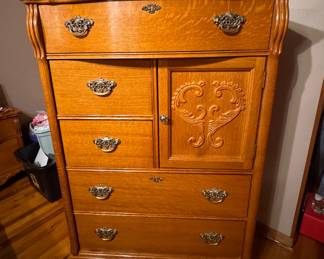 Solid Oak Lexington Furniture Victorian Sampler Collection Door Chest featuring distinctive carved scroll door detailing, quarter-sawn oak grain, and ornate brass-finish hardware. Approx. 33w x 52h x 18d. $500.