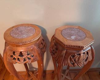 Pair of vintage Asian-style hand-carved wood plant stands or pedestal urn tables with inset mauve marble tops. Approx. 37h x 16w. $125 for the pair.