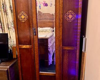 Antique Edwardian or Art Nouveau style mirrored wardrobe likely dating from the 1910's-1920's. Quarter-sawn oak or tiger oak, beveled mirror door. Known as a "knock-down" wardrobe. Approx. 36 1/2 w x 83h x 15 1/2 d.  $350