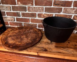 3 Large Round Pizza Stones. $10 each. Antique Three-Legged Cast Iron Pot/Kettle.  $50.