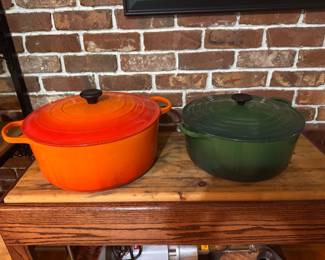 Le Creuset Flame (Volcanic Orange) Oval Dutch Oven. $150. Le Creuset Hunter/Forest Green Round Dutch Oven.  $125. 