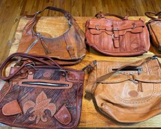 Bottom Left to Right: Berne Two-Tone Fleur-de-Lis Shoulder Bag. $50. Berne Studded Slouchy Hobo Bag. $45. Top Left to Right: Berne Asymmetrical Zipper Hobo Bag. $35. Berne Multi-Strap Flap Satchel. $30. 