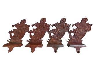 Lot #177 - Solid Cast Iron Santa w Horn in Sleigh "Ho Ho Ho" Christmas Stocking Holders Set of 4