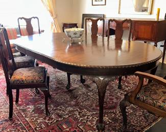 Heriz rug, oval carved walnut dining table, assorted Queen Anne chairs