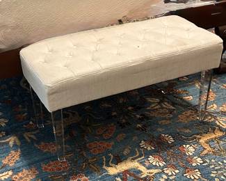 Upholstered bench with lucite legs