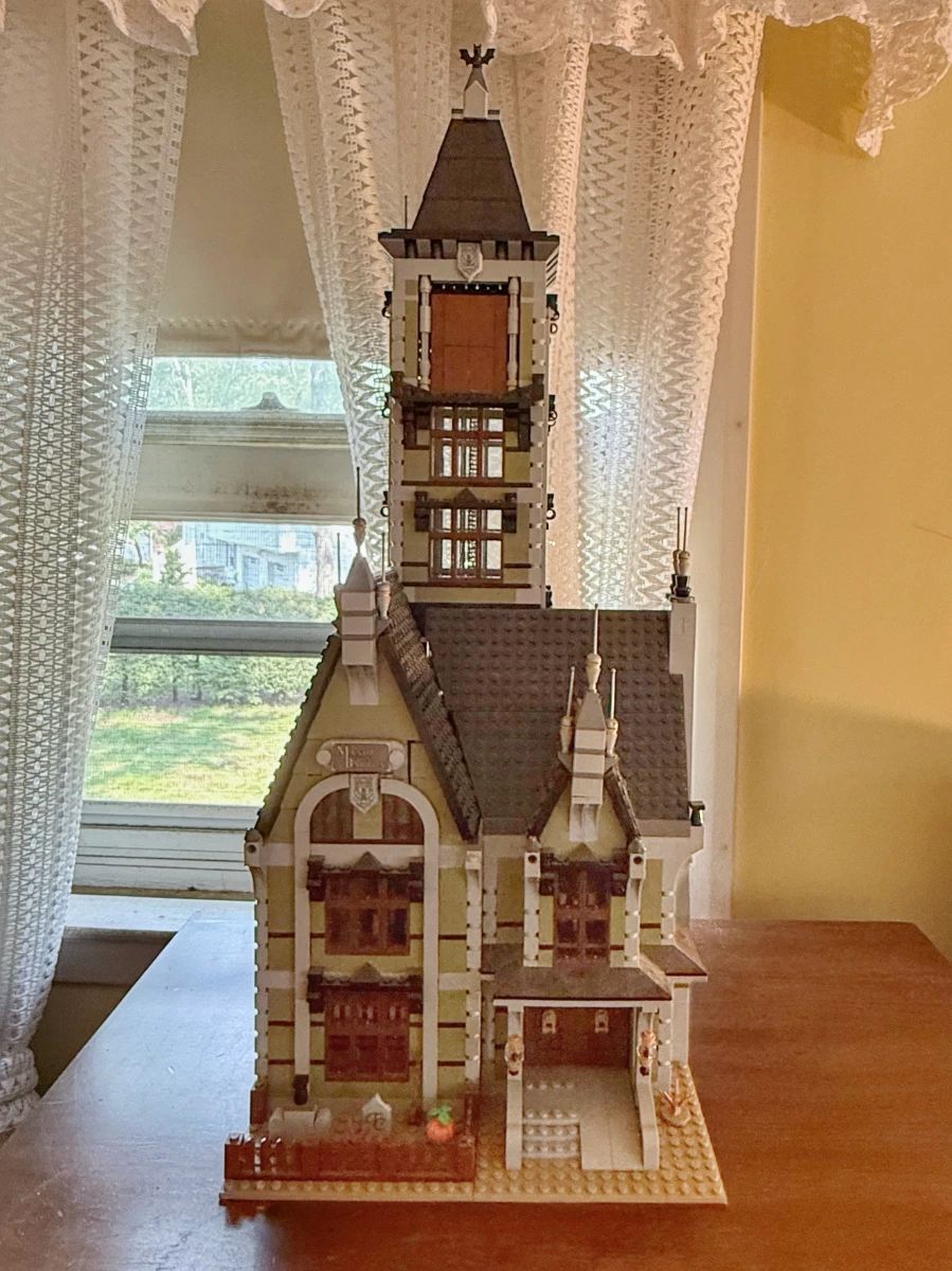 The LEGO Icons Haunted House (Set #10273) is an advanced, retired 3,231-piece building kit featuring a functional free-fall drop tower ride, opening hinged design, and classic manor details.